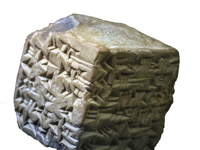Stone cube inscribed with cuneiform. 