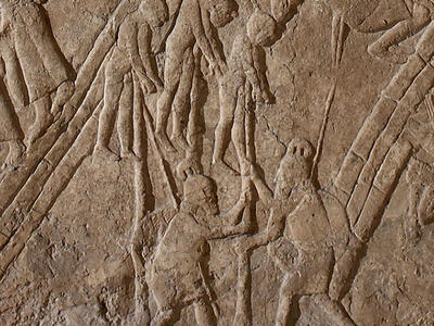 Relief of two people impaling three people. 
