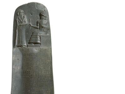 Basalt stela inscribed with Akkadian writing and figure on throne next to standing figure. Inset shows close-up of Akkadian writing. 