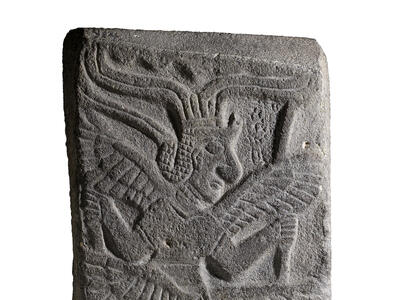 Relief of figure with six wings and headdress.