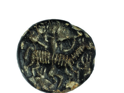Limestone seal with image of antelope and archer.