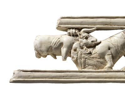 Ivory carving of a sphinx amid lotus flowers.