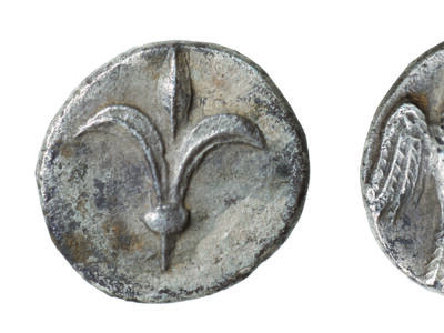 Front and back of coin, with lily on one side and falcon on the other