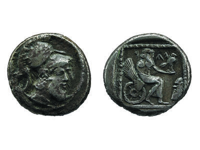 Front of coin depicting head with beard wearing helmet and back of coin depicting figure on winged chariot holding bird.
