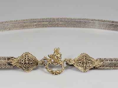 Metal belt with carved clasp.