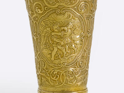 Cup inscribed with angels, birds, and other animals with a floral motif, and Hebrew text across the lip. 