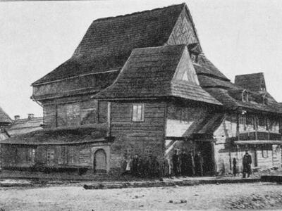 Exterior photograph of wooden building with shingles. 