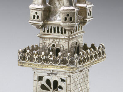 Container in the shape of a four-story tower with doors and windows cut out. 