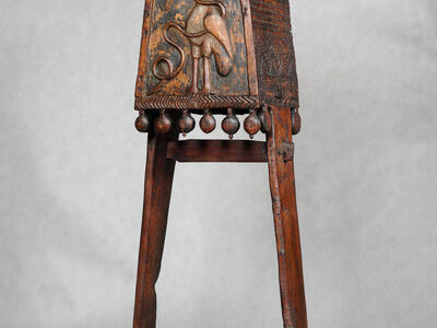 Wooden lectern with stork carving.
