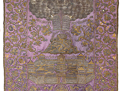 Cloth with embroidered image of tablets in clouds above mountain and city. 