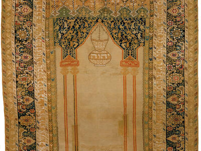 Textile with woven image of two hands at bottom beneath censer and decorative borders. 