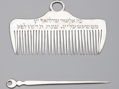 Silver comb and nail pick.
