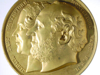 Medal featuring profile portraits of a man and woman.