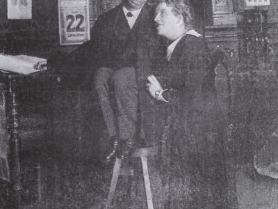 Photograph of two figures looking at each other.