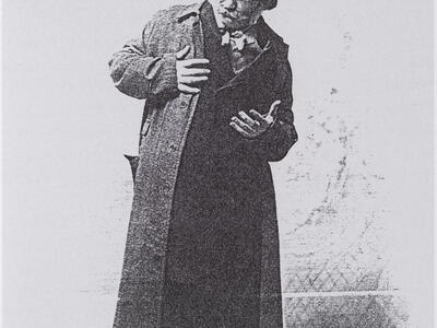 Photograph of man in top hat looking off to the side.