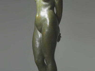 Sculpture of nude woman looking down.