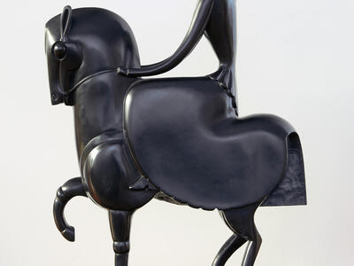 Sculpture of stylized figure on horseback.