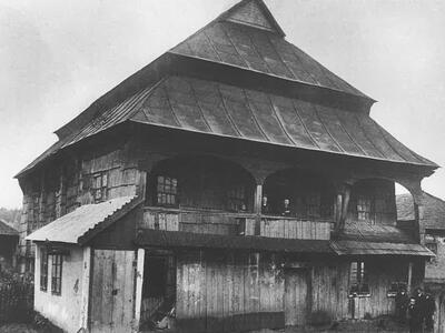 Photograph of wooden building with tiered triangular roof.