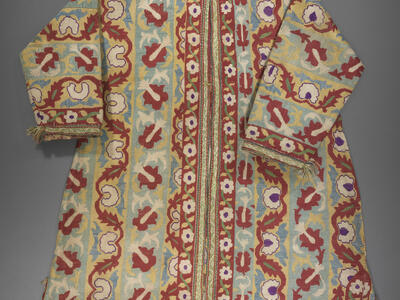 Coat embroidered with flowers, vines, and geometric patterns.