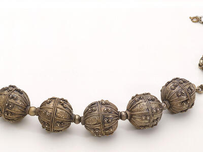 Necklace with five large beads on chain.