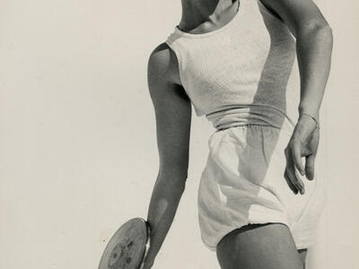 Photograph of female athlete assuming position to throw a discus.