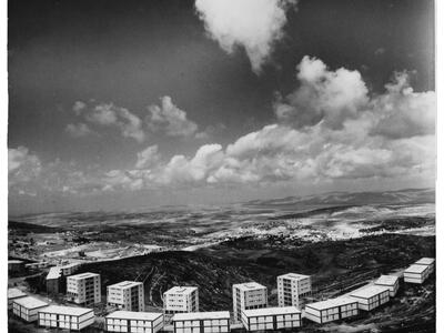 Aerial photograph of rectangular buildings set in landscape. 