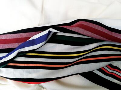 Prayer shawl woven with bands of vibrant colors.