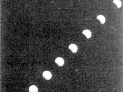 Depiction of nine stages of the moon, from a small sliver in the top right corner to a full moon in the bottom left corner. 