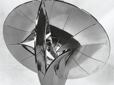 Spherical polished aluminum sculpture resembling two intersecting discs. 