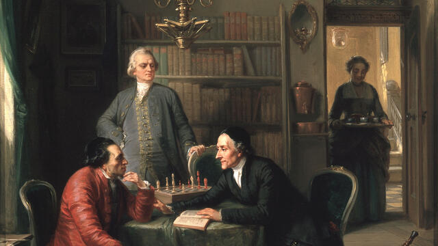 Lavater and Lessing Visit Moses Mendelssohn, 1856 Painting of two men seated at a table with another man standing behind them, and woman in doorway carrying tray of tea.