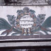 Photograph of Hebrew text in decorated frame with plumage. 