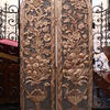 Set of curved doors with carving of peacock-shaped pitcher filled with foliage and fruit extending to top of door. 